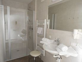 Badezimmer mit begehbarer Dusche und Toilette