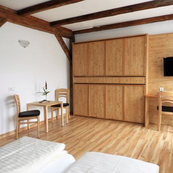 Geräumiges Zimmer mit Holzbalken und Einbauschrank